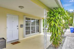 a house with a white door and some plants at Endless Summer in Pompano Beach