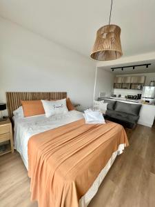 a bedroom with a large bed with an orange blanket at Dorrego 1781 in Buenos Aires