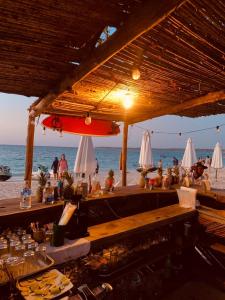 a bar on the beach with a view of the ocean at ROCHA BEACH CLUB in Barú
