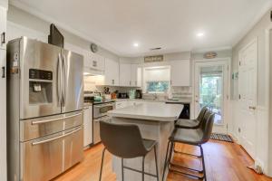 a kitchen with a stainless steel refrigerator and two chairs at 3009 Cameron in Isle of Palms