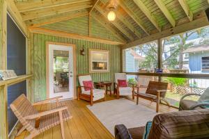 a screened in porch with chairs and a table at 3009 Cameron in Isle of Palms
