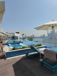 a swimming pool on the roof of a building at Beachside Bliss: Stylish New Studio at Seven Palm in Dubai