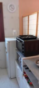 a microwave sitting on a counter in a kitchen at La Cuestina in Llánaves de la Reina