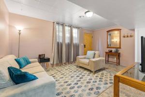 a living room with a couch and a chair at Cozy Holiday Hideaway King Bed Free Parking in Boise