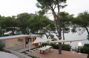 a house on the water with a wooden deck at Villa Liore in Marina