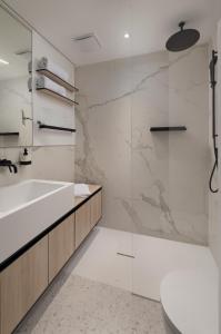 a bathroom with a tub and a sink and a toilet at Villa Liore in Marina +34 photos