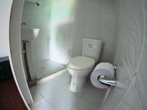 a small bathroom with a toilet and a sink at Posada nativa casa azul in Playa Blanca