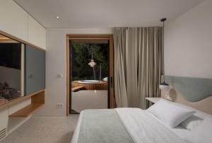 a bedroom with a bed and a desk and a table at Villa Liore in Marina