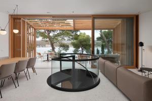 a living room with a glass table and a couch at Villa Liore in Marina