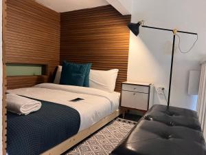 a bedroom with a bed with a wooden headboard at Prince of Beer Sheva by CROWN in Beer Sheva