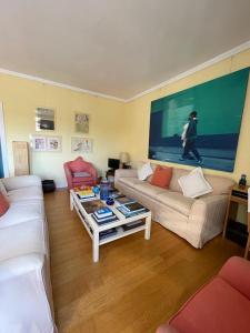 a living room with two couches and a large painting at Zattere apartment - Casa Gardella in Venice