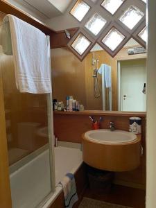 a bathroom with a sink and a mirror at Zattere apartment - Casa Gardella in Venice