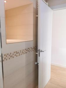 a bathroom with a shower with a glass door at Villa con patio in Madrid