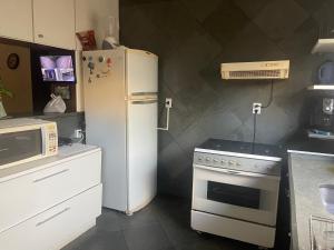 a kitchen with a refrigerator and a stove at Lu in Itu +15 photos