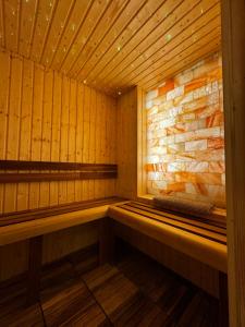 a wooden sauna with a bench in the middle at TOP Luxury Suites in Budapest