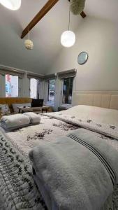 a large bedroom with two beds with pillows on them at Charming Private Guest House in Enfield