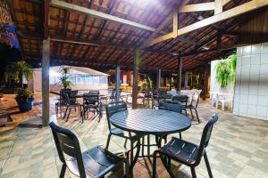 a patio with a table and chairs and tables at Hotel Morro De Santo Agostinho in Serra Negra