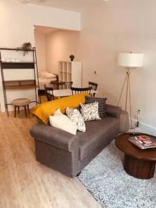 a living room with a couch and a table at Dream Living in Syracuse