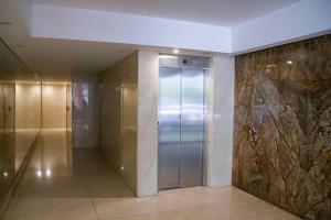 a hallway with a elevator in a building at Regatas Las Cañitas Suites in Buenos Aires