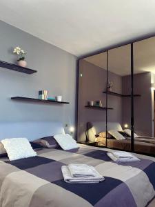 a bedroom with two beds and a large mirror at Holiday Lido Cannobio in Cannobio