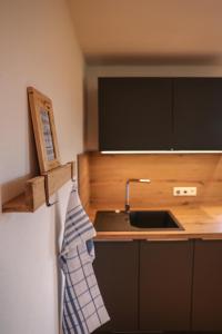 a kitchen with a sink and a counter top at Ferienwohnung Söldenköpfl-Blick in Schönau am Königssee +26 photos
