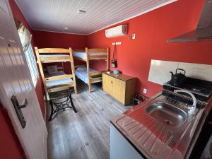a small kitchen with a sink and a bunk bed at Casa Conteiner en campo con playa privada. max 6 personas in Jaureguiberry
