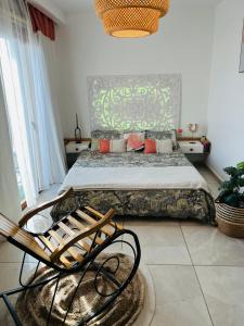 a bedroom with a bed and a chair at Standing de luxe, surface de 150 m Paiement uniquement en euros in Oran