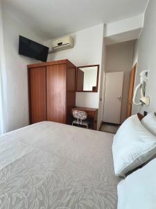 a hotel room with a large bed and a desk at Hotel B&B Ardea Rimini in Rimini