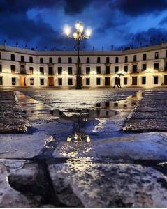 a building with a person walking in front of it at night at Casa Pérez in Aguilar de la Frontera