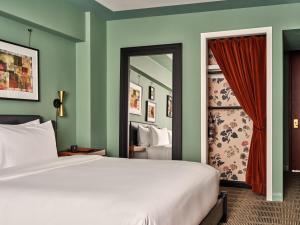 a bedroom with a white bed and a mirror at Romer Hell's Kitchen in New York +37 photos