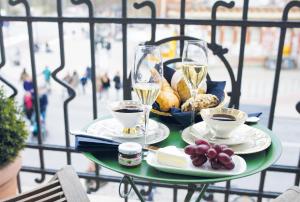 a table with glasses of champagne and a plate of food at Fritz im Pyjama in Hamburg
