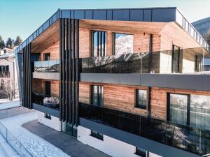 a building with black and wood at Chalet Larix Andalo Deluxe Apartments in Andalo