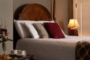 a bedroom with a bed with white and red pillows at 300 Clifton in Minneapolis