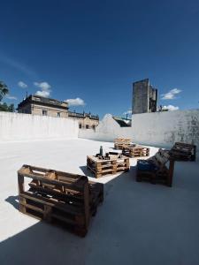 a group of wooden benches sitting on top of a roof at B61 house in Concordia