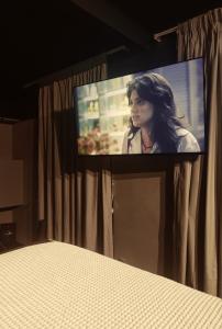 a flat screen tv sitting on top of a curtain at Loft Sagitárius - Central Zone - Lotk1 in Rio de Janeiro