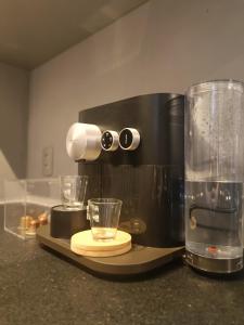 a coffee maker sitting on a counter with two glasses at Loft Sagitárius - Central Zone - Lotk1 in Rio de Janeiro