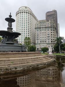 a fountain in a city with buildings in the background at Loft Sagitárius - Central Zone - Lotk1 in Rio de Janeiro