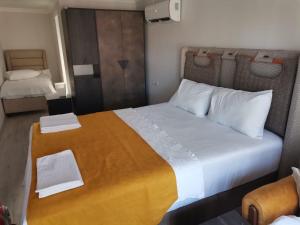 a bedroom with a large bed with two towels on it at Zeyos in Kumluca