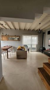 a living room with a couch and a table at Casa del parque in Necochea