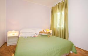 a bedroom with a green bed and a table at Villa Olive Tree in Kaštela