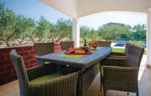 a table with a plate of fruit on a patio at Villa Olive Tree in Kaštela