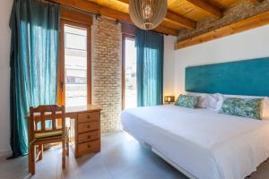 a bedroom with a large bed and a wooden ceiling at Mediterranean Gem Getaway in Valencia