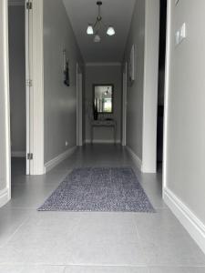 a hallway with a rug on the floor at Maria's Haven in Santo António