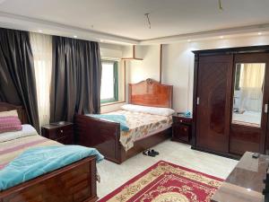 1 dormitorio con 2 camas y ventana en شقق فندقيه بمدينه المنصوره en Ṭalkha