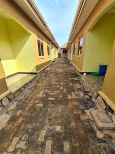 an empty hallway of a building with a cobblestone street at Tizo comfort homes in Wakiso