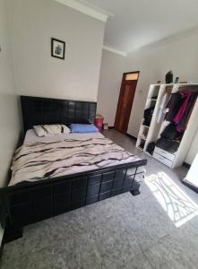 a bedroom with a large bed in a room at Tizo comfort homes in Wakiso