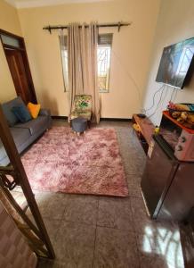 a living room with a couch and a rug at Tizo comfort homes in Wakiso