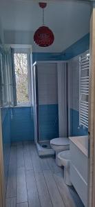 a bathroom with a tub and a toilet and a window at Casadduoglio home costa d'Amalfi in Vietri sul Mare