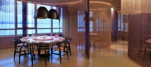 a dining room with a table and some chairs at Symphony Style Hotel Kuwait in Kuwait