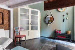 a living room with a chair and a mirror at Il Pozzo di Santa Teresa in Catania